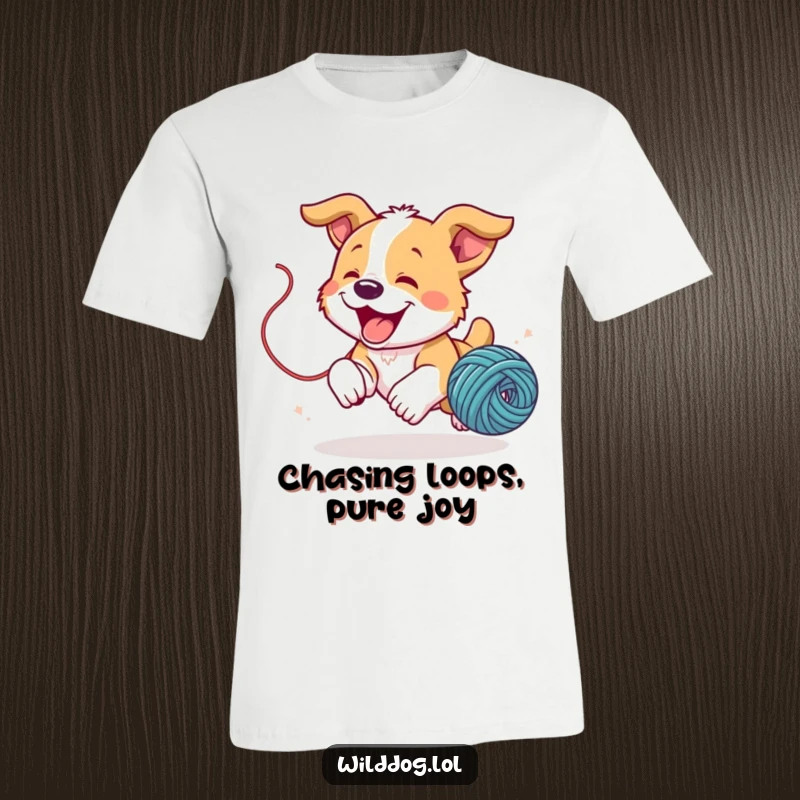 Funny wild dog puppy joyfully chasing a bouncing ball of yarn on a t-shirt, capturing playful excitement.